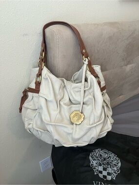 Vince Camuto Cream Shoulder Bag with Tan Handles and Gold Medallion